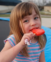 Girl holding a red popsicle